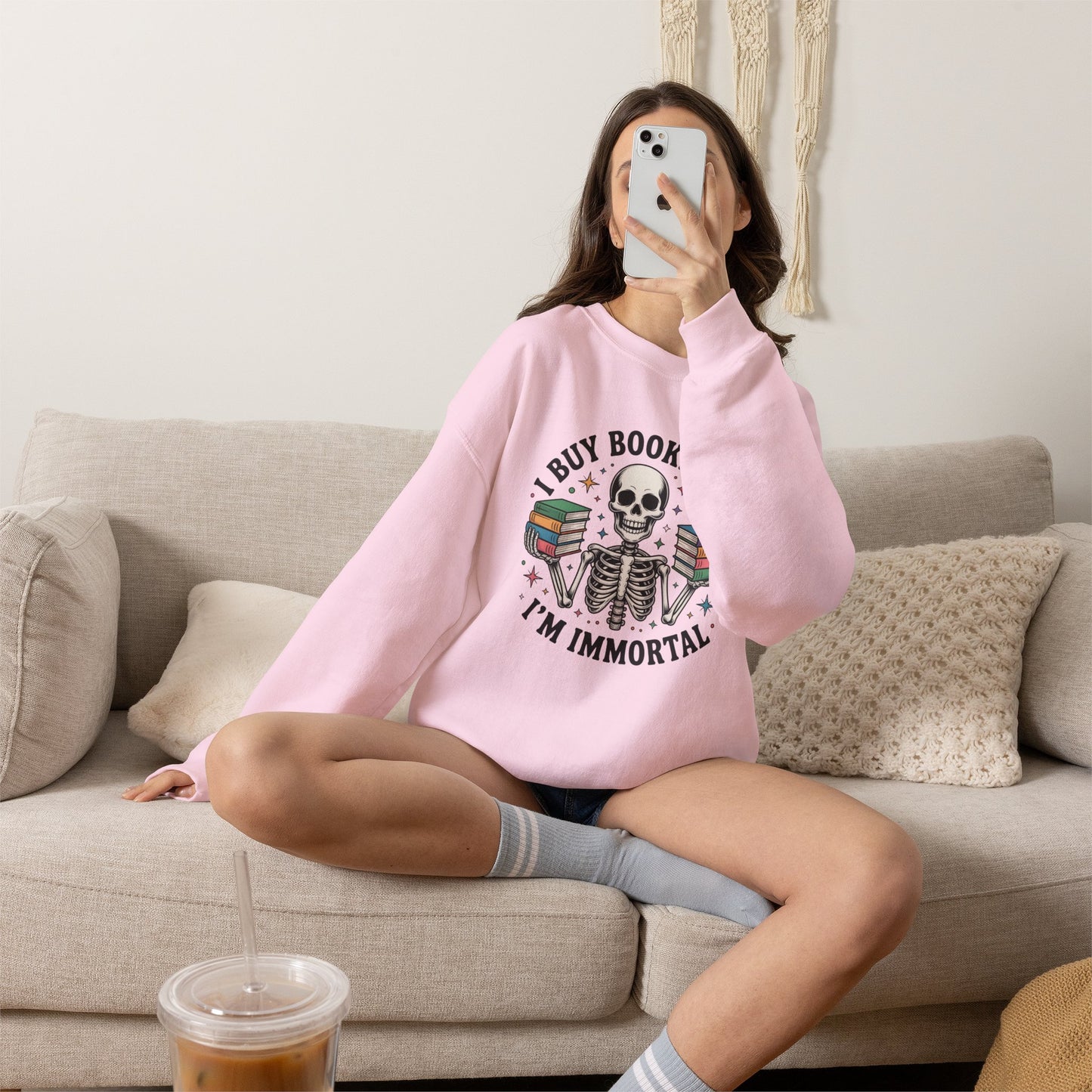 Book Lover Sweatshirt — "I Buy Books Like I’m Immortal" Skeleton Reading Crewneck - Back has Northkind's blueprint for bookish heaven