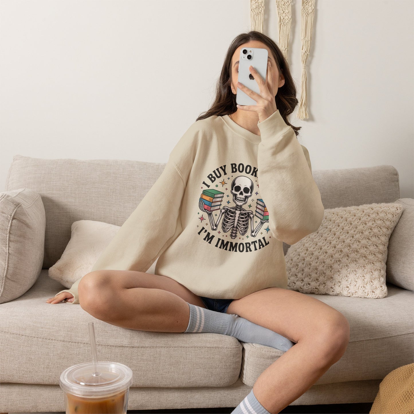Book Lover Sweatshirt — "I Buy Books Like I’m Immortal" Skeleton Reading Crewneck - Back has Northkind's blueprint for bookish heaven