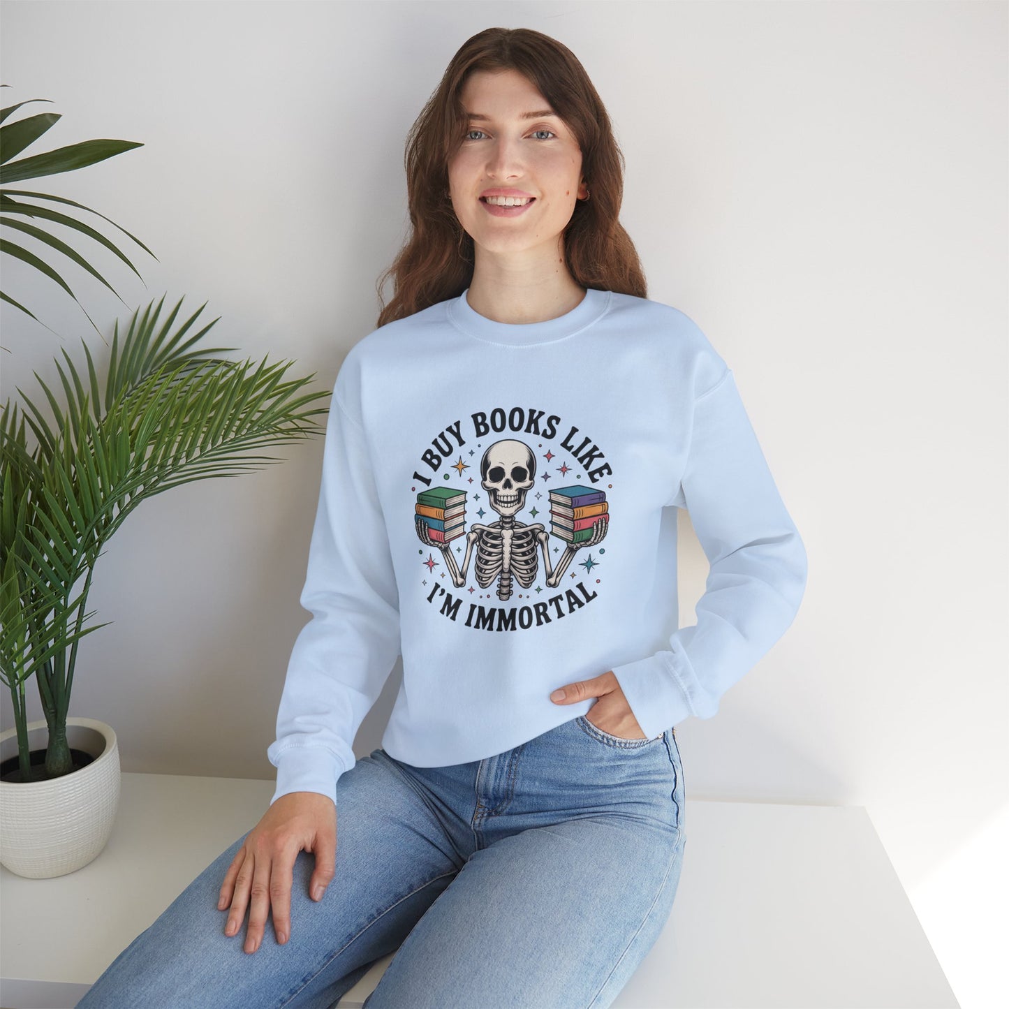 Book Lover Sweatshirt — "I Buy Books Like I’m Immortal" Skeleton Reading Crewneck - Back has Northkind's blueprint for bookish heaven