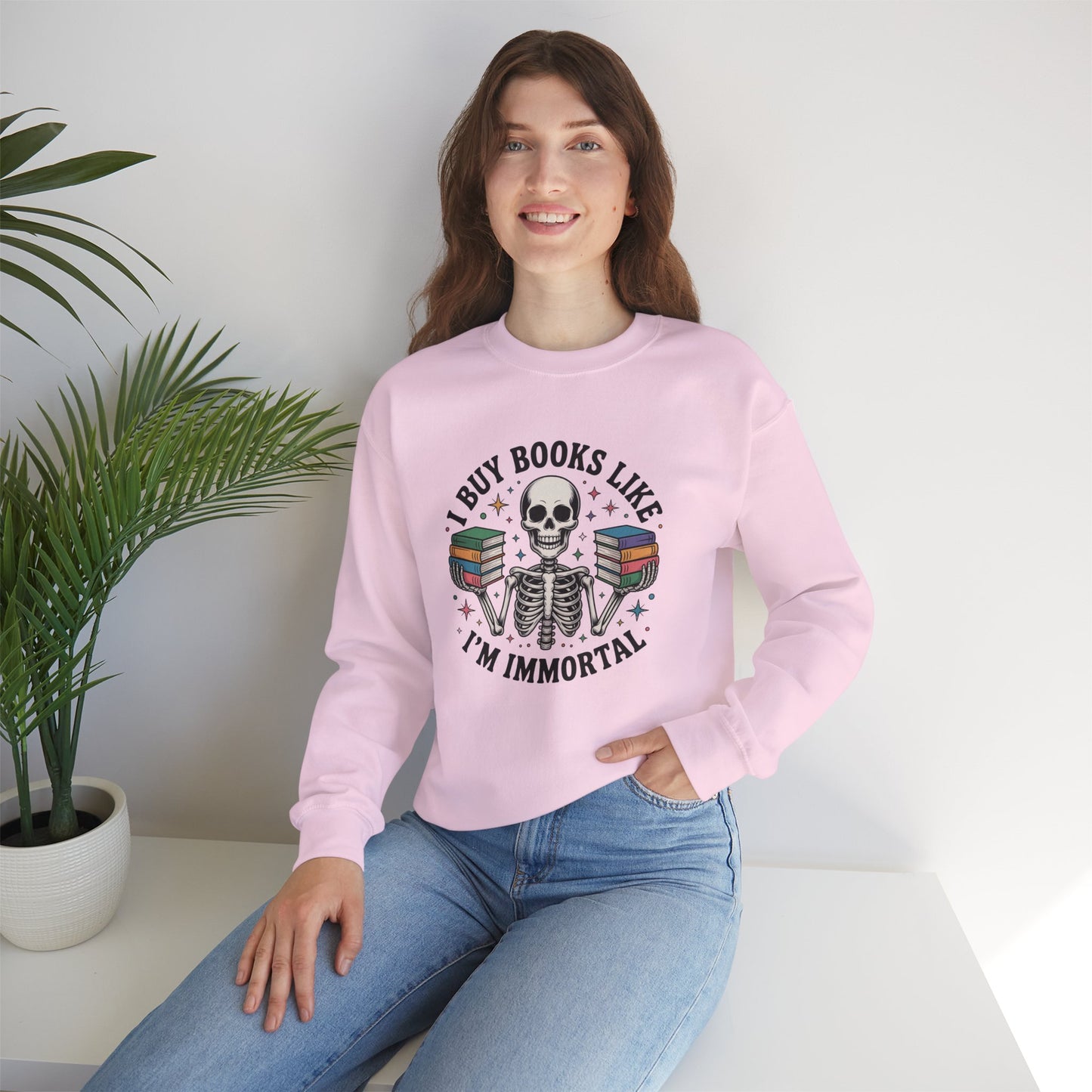 Book Lover Sweatshirt — "I Buy Books Like I’m Immortal" Skeleton Reading Crewneck - Back has Northkind's blueprint for bookish heaven